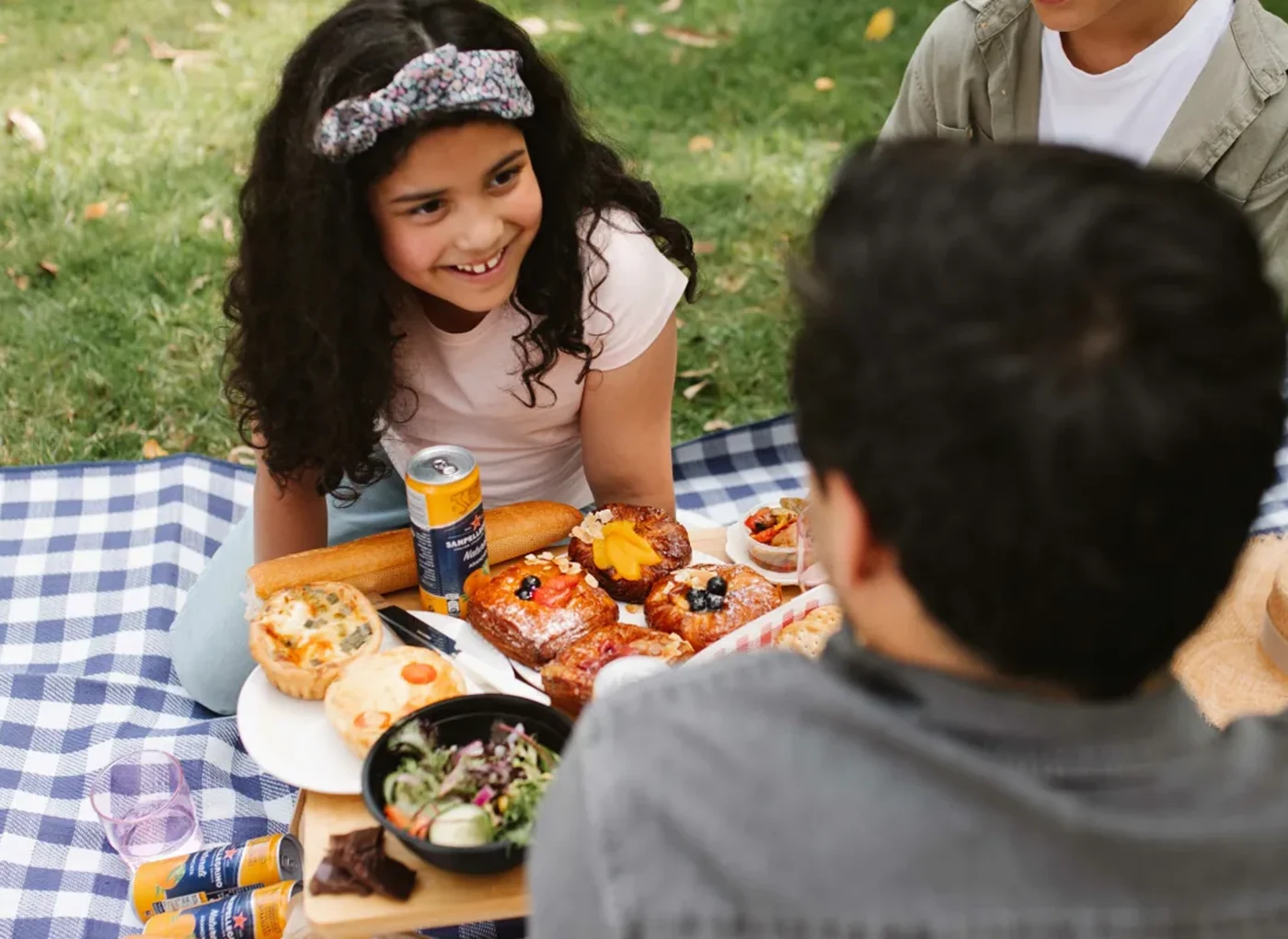 Children enjoying picnic food during a Belfast Mystery Picnic family activity